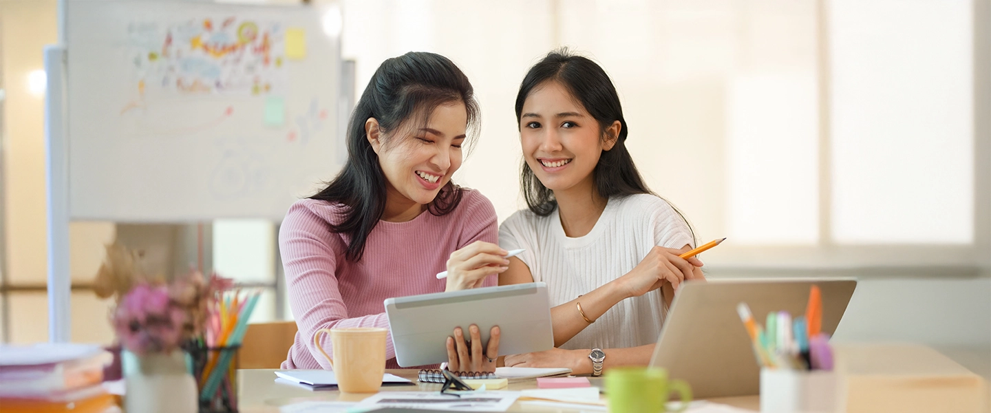 Parent or caregiver with child doing homework at table