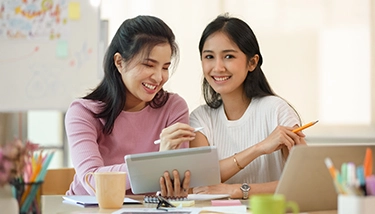 Parent or caregiver with child doing homework at table